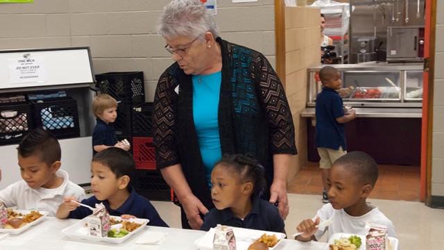 Principal Mary Coughlin with pre-K students in the lunchroom at Spencer Elementary as they have their first Free Lunch. (Mark Hancock)