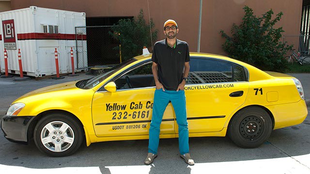 Yellow Cab driver, Abdul Nachi, poses in his waiting spot in downtown OKC. (Mark Hancock)