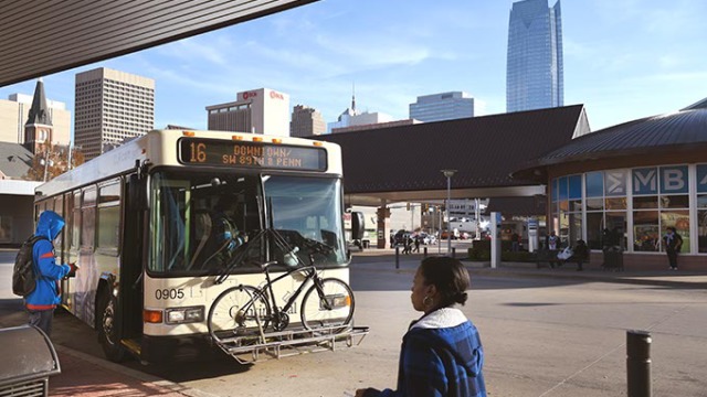 Riders walk up to a bus in the Downtown OKC Transit Station. (Mark Hancock)