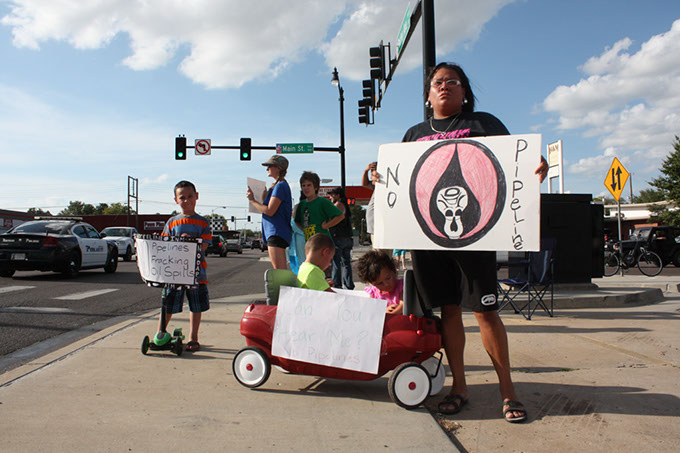 Cleveland County resident Maria Todd stands with her children and a group of demonstrators opposed to the Plains All American Pipeline running through south central Oklahoma. Demonstrators stood at Norman street corners on Sept. 7.  (Laura Eastes)